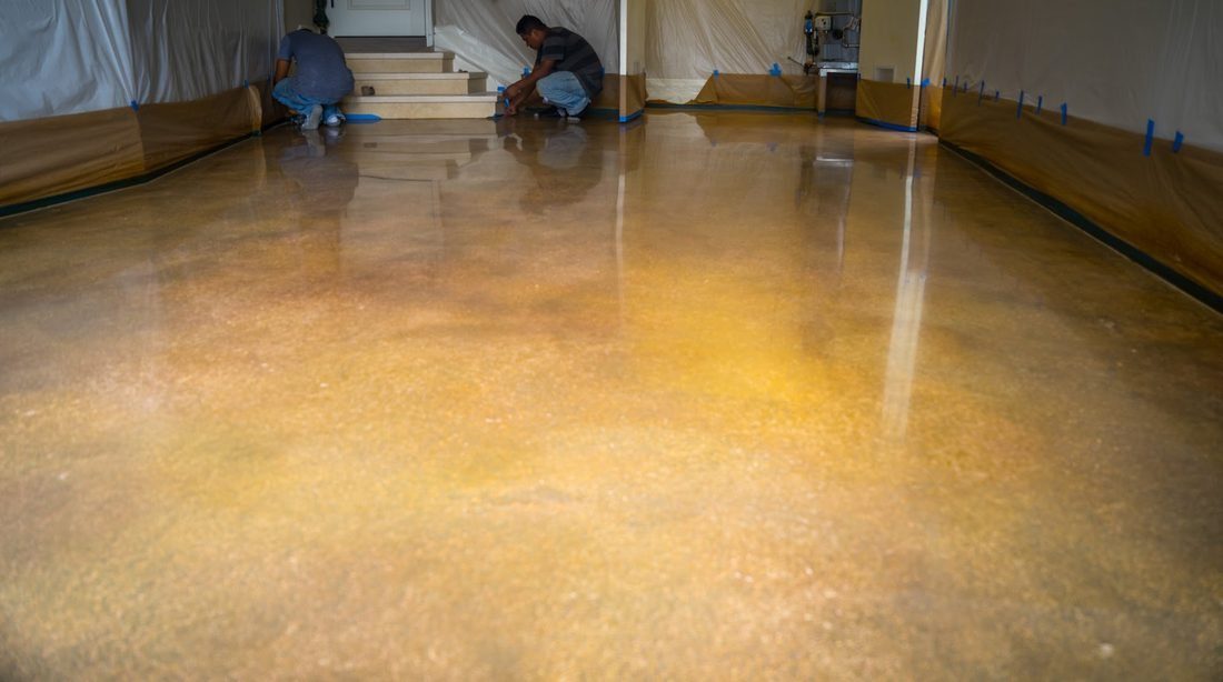 Installers finishing a glossy coated floor